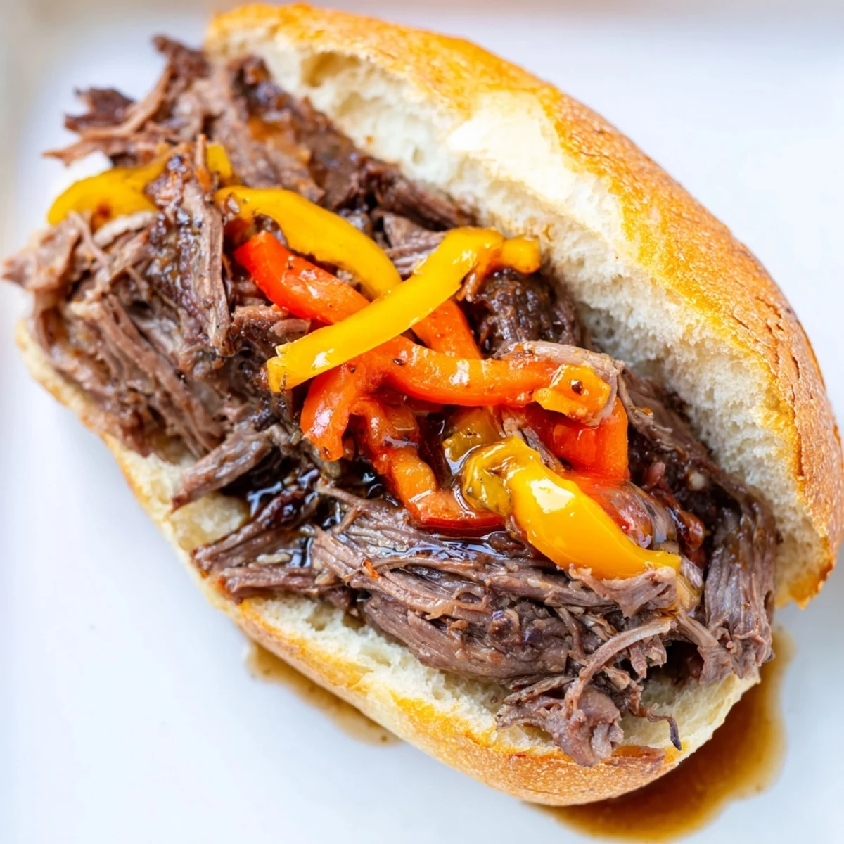 Juicy Italian Beef Sandwich overflowing with tender beef and spicy giardiniera, ready to enjoy.