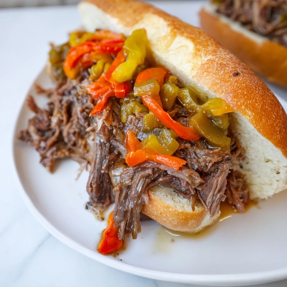 Savory Italian Beef Sandwich, layered with tender beef and pickled vegetables, perfect for a hearty meal.