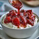 Creamy Greek yogurt topped with homemade strawberry compote and a drizzle of honey.  