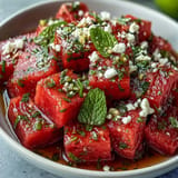 Cool, zesty, and refreshing watermelon chili lime salad with mint garnish.
