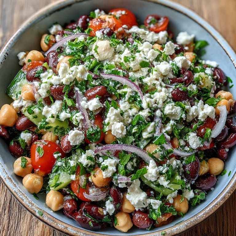 Meal-prep friendly Divorce Salad in a glass bowl, topped with tangy feta and sliced red onions.