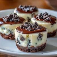 Mini cheesecake bites with Oreo crust, baked golden brown and ready to serve.